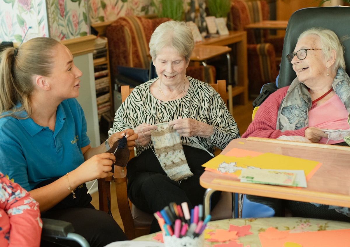 Care home residents enjoying an activity with a carer